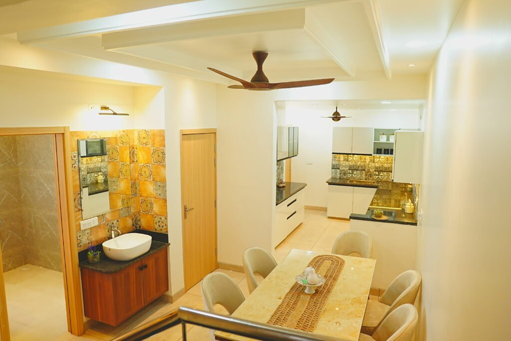 "Spacious and modern living area with comfortable seating, a large flat-screen TV, and floor-to-ceiling windows with stunning views. The dining area features a stylish table with seating for six, and the open-plan kitchen boasts top-of-the-line appliances and sleek cabinetry. The bedroom is elegantly designed with a cozy bed, luxurious linens, and ample closet space. The bathroom is equipped with a large soaking tub, separate walk-in shower, and double vanity. The decor throughout the apartment is contemporary and chic, creating a luxurious and welcoming atmosphere."
